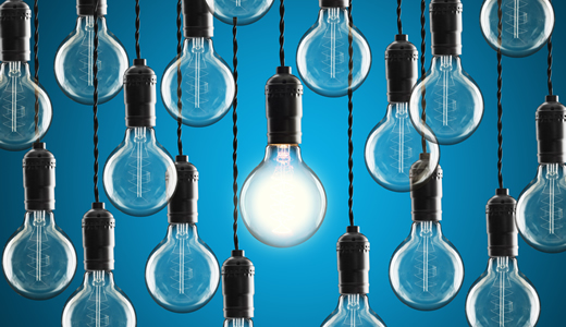 Various Light Bulbs Hanging down with a Blue background 
